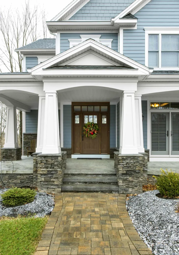 Stone veneer entryway with covered porch and column accents