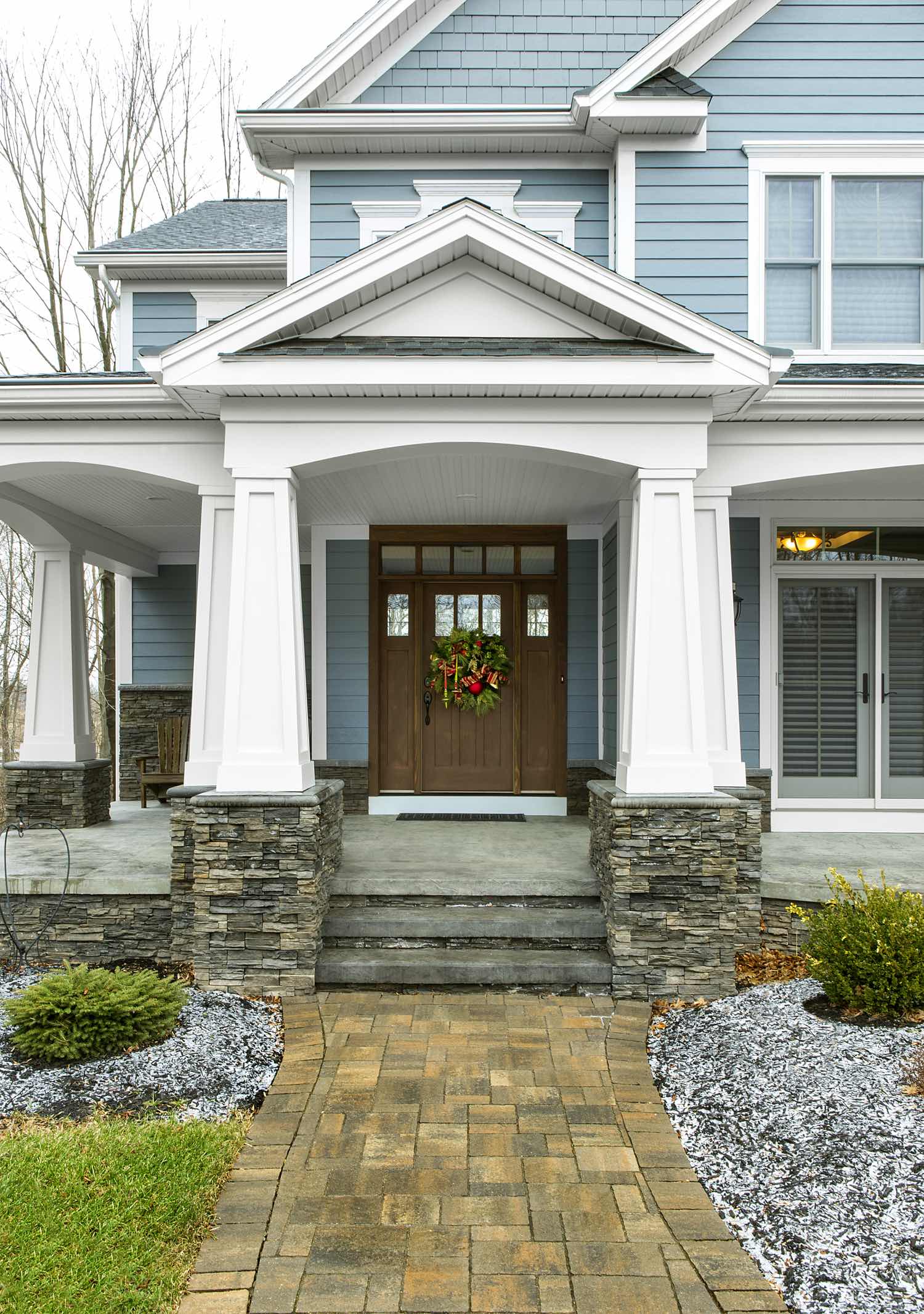 Stone veneer entryway with covered porch and column accents
