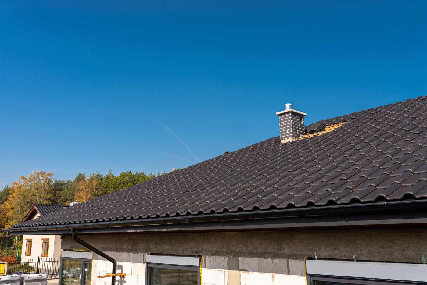 Close-up of metal roofing panels in a variety of custom colors and textured finishes